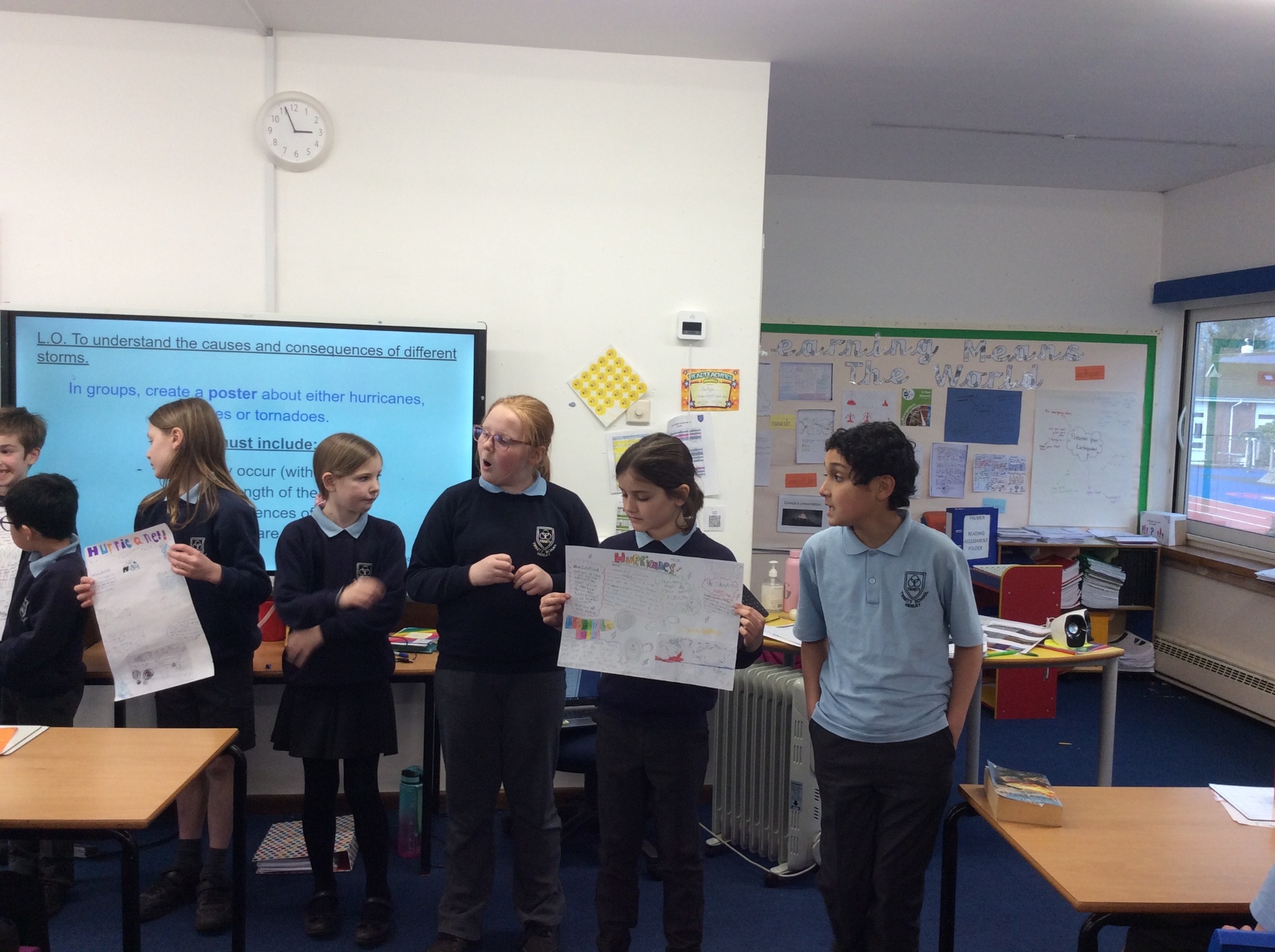 Children showing their work to the class photo